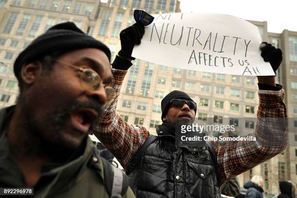 Demonstrators rally outside the Federal Communication Commission building to protest against the end of net neutrality rules December 14, 2017 in...
