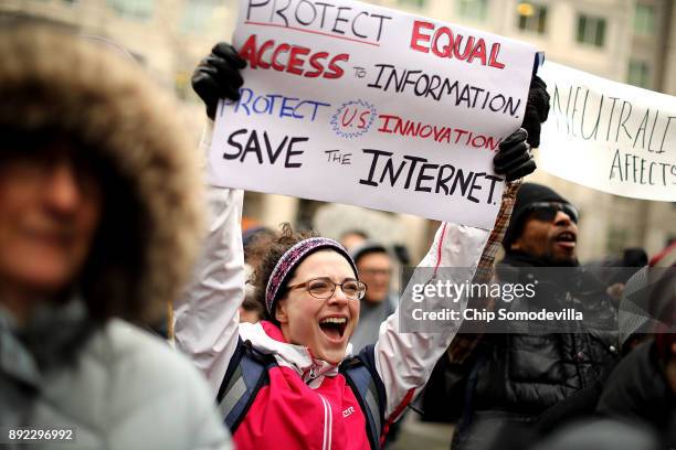 Demonstrators rally outside the Federal Communication Commission building to protest against the end of net neutrality rules December 14, 2017 in...