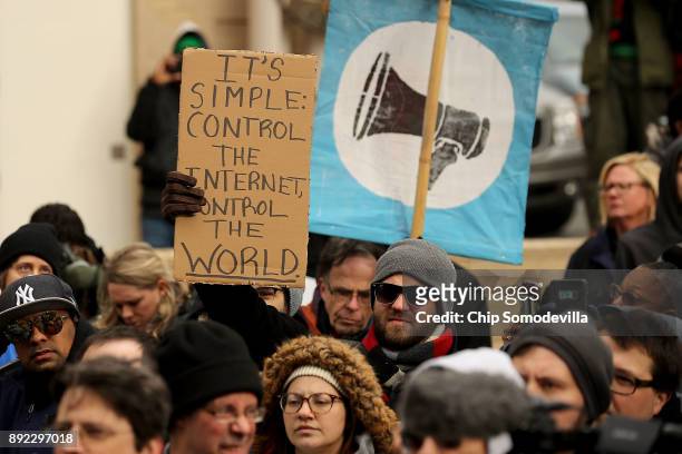 Demonstrators rally outside the Federal Communication Commission building to protest against the end of net neutrality rules December 14, 2017 in...