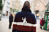 young man with a paper man attached to his back