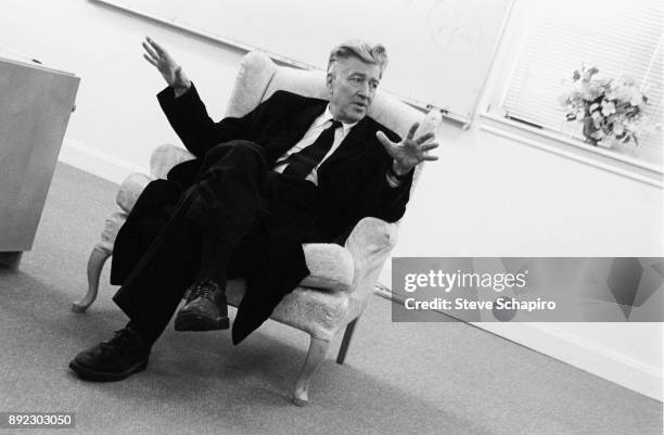 View of American film director David Lynch, seated in an armchair, as he gestures while he speaks, Iowa, 2005.