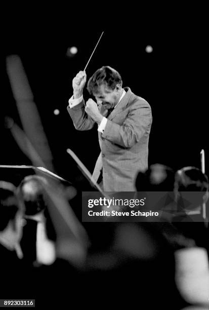 View of American composer, musician, and conductor Leonard Bernstein as he conducts a performance at Carnegie Hall, New York, New York, 1959.