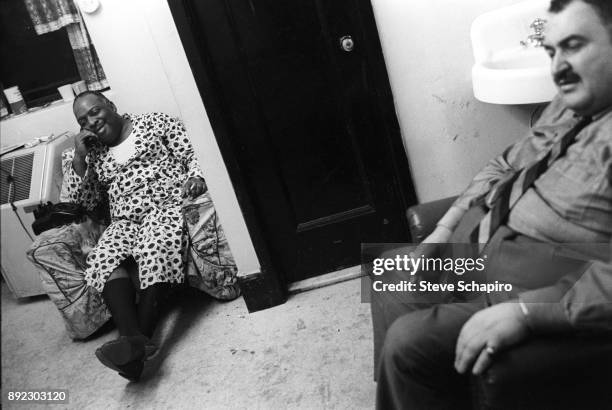 Backstage at the Apollo Theater, American Jazz musician and bandleader Count Basie , in a dressing gown, talks on the telephone, New York, New York,...