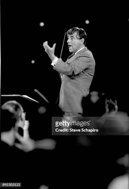 View of American composer, musician, and conductor Leonard Bernstein as he conducts a performance at Carnegie Hall, New York, New York, 1959.