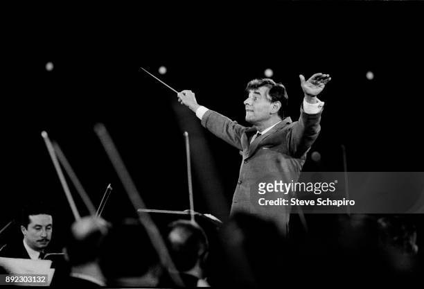 View of American composer, musician, and conductor Leonard Bernstein as he conducts a performance at Carnegie Hall, New York, New York, 1959.