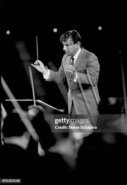 View of American composer, musician, and conductor Leonard Bernstein as he conducts a performance at Carnegie Hall, New York, New York, 1959.