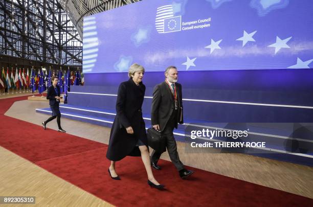 Britain's Prime minister Theresa May and UK Permanent Representative to the EU Tim Barrow arrive to attend the first day of a European union summit...