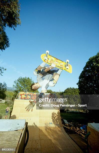 Rob Washburn does an invert over the channel of the Cito Ramp, a backyard half pipe, in March 1985 in Montecito, California.