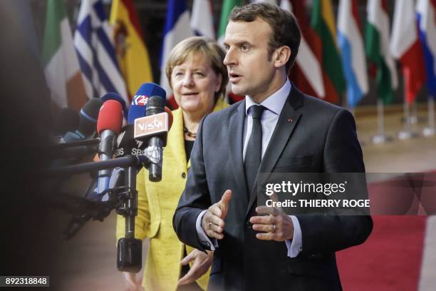 Germany's Chancellor Angela Merkel and France's President Emmanuel Macron answer the press as they arrive to attend the first day of a European union...