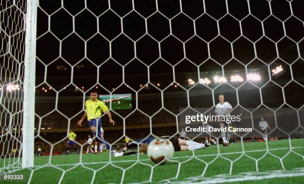 Oliver Kahn of Germany is beaten as Ronaldo of Brazil scores the opening goal during the Germany v Brazil, World Cup Final match played at the...