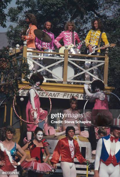 View of, atop bus from left, musicians Barry and Maurice Gibb , Peter Frampton , and Robin Gibb , along with Sandy Farina , in a scene from the film...