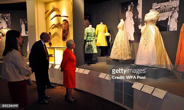 Queen Elizabeth II is shown around the Commonwealth exhibition at Buckingham Palace by Sir Hugh Roberts, Director of the Royal Collection and and...