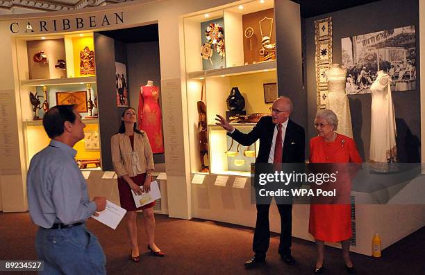 Queen Elizabeth II is shown around the Commonwealth exhibition at Buckingham Palace by Sir Hugh Roberts, Director of the Royal Collection and and...