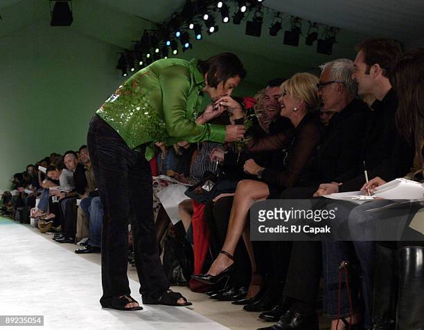 Model wearing Zang Toi Spring 2004 kisses the hand of Ivana Trump