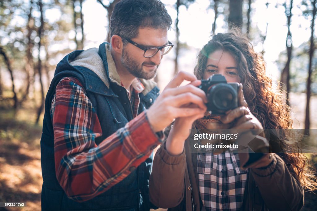 Couple taking pictures outdoors