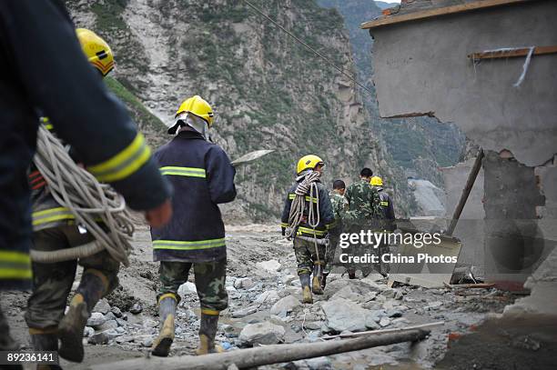 Paramilitary policemen walk to carry out rescue work after a landslide on July 24, 2009 in Kangding County of Ganzi Tibetan Autonomous Prefecture,...