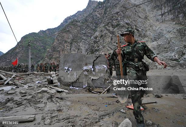 Paramilitary policemen carry out rescue work after a landslide on July 24, 2009 in Kangding County of Ganzi Tibetan Autonomous Prefecture, Sichuan...
