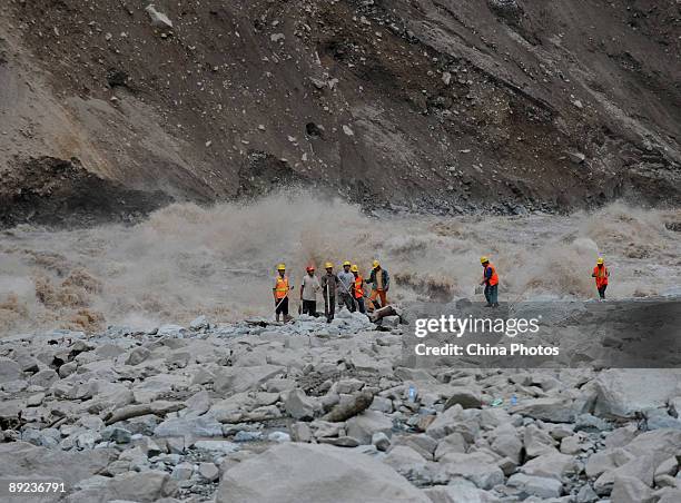 Workers carry out rescue work after a landslide on July 24, 2009 in Kangding County of Ganzi Tibetan Autonomous Prefecture, Sichuan Province, China....