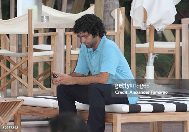 Adrian Grenier lounges poolside at the Entourage Bungalow at W South Beach on July 23, 2009 in Miami Beach, Florida.