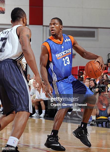 Toney Douglas of the New York Knicks surveys the court against Andre Owens of the Detroit Pistons during NBA Summer League presented by EA Sports on...