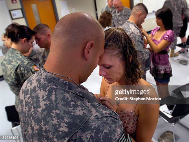 Married just over a month, Amy Cosens and her husband U.S. Army PFC Lee Cosens exchange half of a pewter coin during the 3rd Infantry Division's...