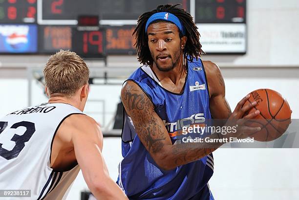 Jordan Hill of the New York Knicks handles the ball against Jonas Jerebko of the Detroit Pistons during NBA Summer League presented by EA Sports on...