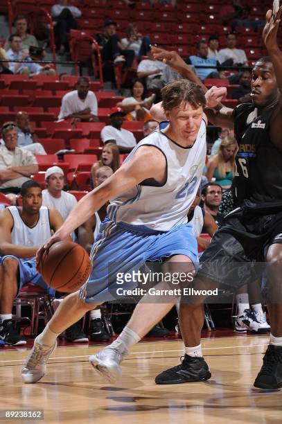 Coby Karl of the Denver Nuggets drives against Jason Rich of the Washington Wizards during NBA Summer League presented by EA Sports on July 15, 2009...