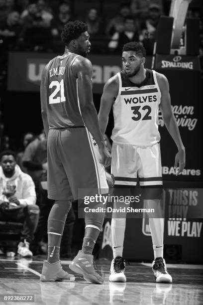 Karl-Anthony Towns of the Minnesota Timberwolves and Joel Embiid of the Philadelphia 76ers stand on the court during the game on December 12, 2017 at...