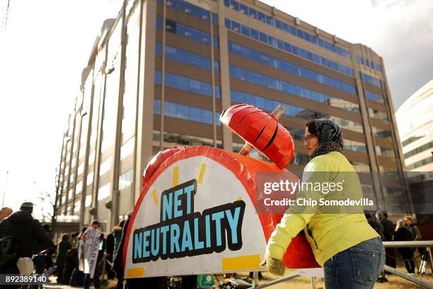 Rally organizers carry away props following a protest outside the Federal Communication Commission building against the end of net neutralityrules...