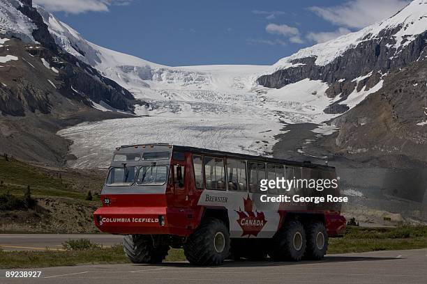 Large Brewster all-terrain tour bus, with the Columbia Glacier in the background, is seen in this 2009 Jasper National Park, Alberta, Canada, summer...