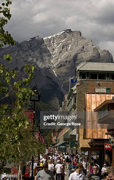 With Cascade Mountain as a backdrop, hundreds of tourists crowd Banff Avenue during the Canada Day celebration in this 2009 Banff Springs, Canada,...