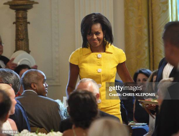 First Lady Michelle Obama arrives to addresses the 10th annual Design Awards luncheon in the East Room of The White House in Washington, DC, on July...
