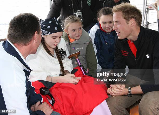 Britain's Prince William, right, is seen with Jade Arnell, second left, and her sisters as he meet's children and their families who are looked after...