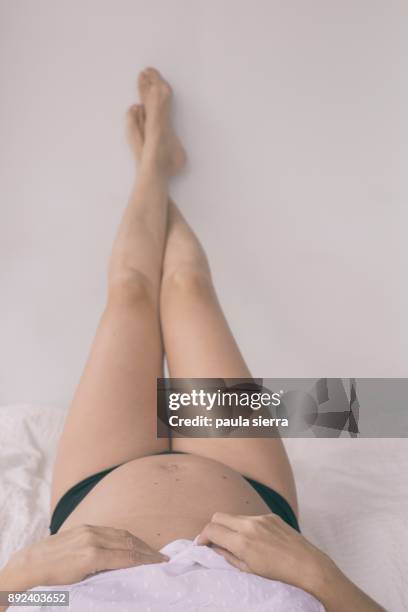 a pregnant woman is at bed - benton bildbanksfoton och bilder