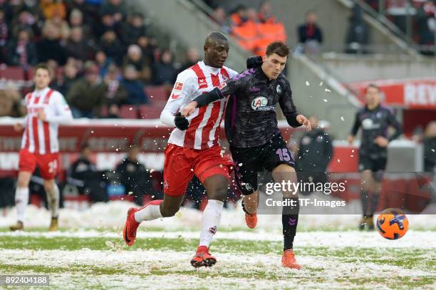 Sehrou Guirassy of Koeln and Pascal Stenzel of Freiburg battle for the ball during the Bundesliga match between 1. FC Koeln and Sport-Club Freiburg...