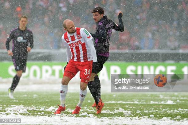 Konstantin Rausch of Koeln and Pascal Stenzel of Freiburg battle for the ball during the Bundesliga match between 1. FC Koeln and Sport-Club Freiburg...