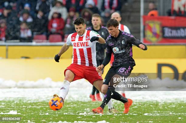 Milos Jojic of Koeln and Pascal Stenzel of Freiburg battle for the ball during the Bundesliga match between 1. FC Koeln and Sport-Club Freiburg at...