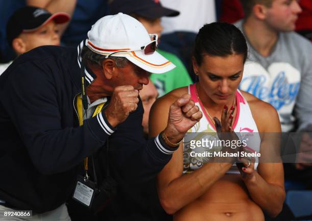 Yelena Isinbayeva of Russia looks despondent as she is spoken to by coach Petrov Vitali during the Women's Pole Vault during day one of the Aviva...