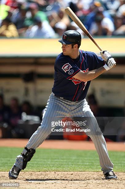 Joe Mauer of the Minnesota Twins bats against the Oakland Athletics during the game at the Oakland-Alameda County Coliseum on July 22, 2009 in...