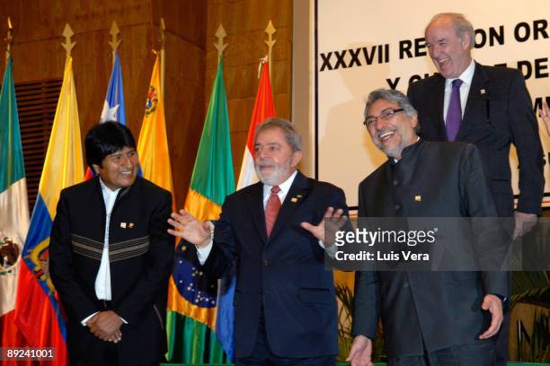 Presidents Evo Morales , Luiz Inacio Lula da Silva and Fernando Lugo , and Peru's Foreign Minister Jose Garcia laugh during the official photo...