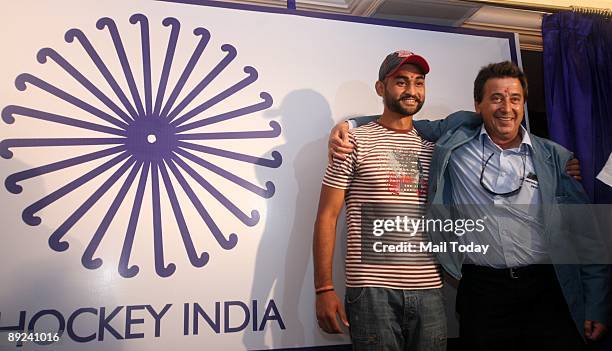 Indian hockey team captain Sandeep Singh and coach Jose Brasa pose prior to the unveiling of the new team logo in New Delhi on Thursday, July 23,...