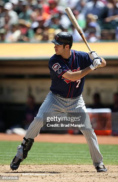Joe Mauer of the Minnesota Twins bats against the Oakland Athletics during the game at the Oakland-Alameda County Coliseum on July 22, 2009 in...