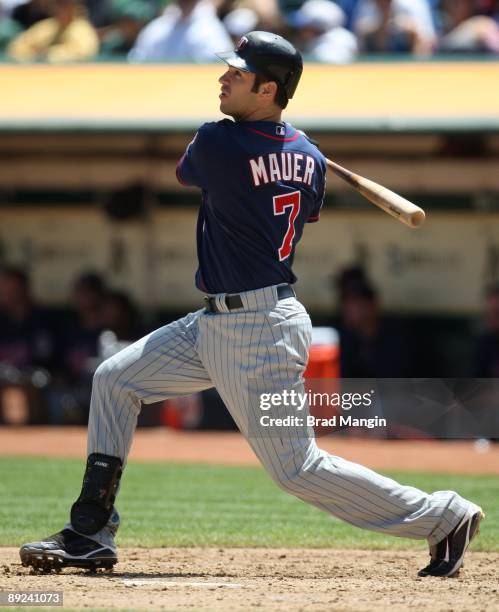 Joe Mauer of the Minnesota Twins bats against the Oakland Athletics during the game at the Oakland-Alameda County Coliseum on July 22, 2009 in...