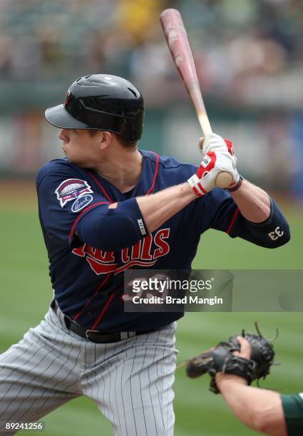 Justin Morneau of the Minnesota Twins bats against the Oakland Athletics during the game at the Oakland-Alameda County Coliseum on July 22, 2009 in...