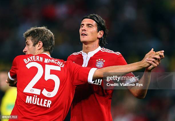 Mario Gomez of Bayern is celebrated by his team mate Thomas Mueller after scoring the 0:1 goal during the pre-season friendly match between 1. FC...