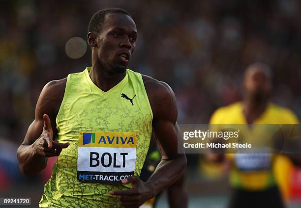 Usain Bolt of Jamaica celebrates as he wins the Men's 100 Metres Final during day one of the Aviva London Grand Prix track and field meeting at...