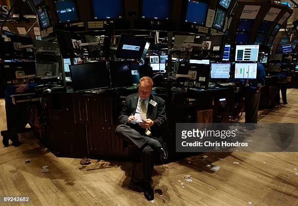 Financial professional works on a quiet Friday afternoon floor of the New York Stock Exchange at the end of the trading day at the July 24, 2009 in...