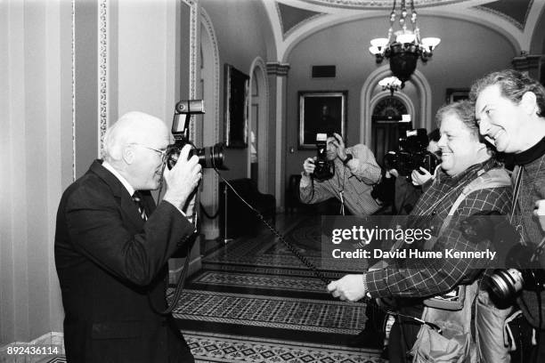 Sen. Pat Leahy, an amateur photographer, talks with photojournalists Scott Applewhite and Chuck Kennedy in the halls of the U.S. Capitol Building...