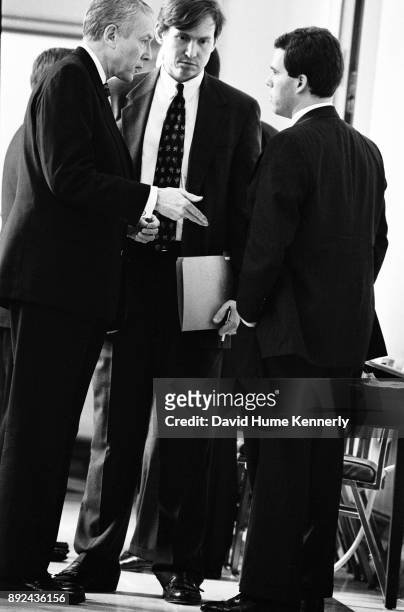 Republican Sen. Orrin Hatch, of Utah, confers with aides during the Senate Impeachment Trial of President Bill Clinton on Jan. 15, 1999.
