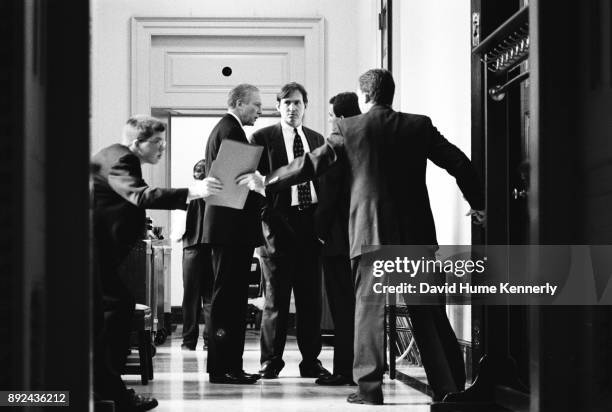 Republican Sen. Orrin Hatch, of Utah, confers with aides during the Senate Impeachment Trial of President Bill Clinton on January 15, 1999.